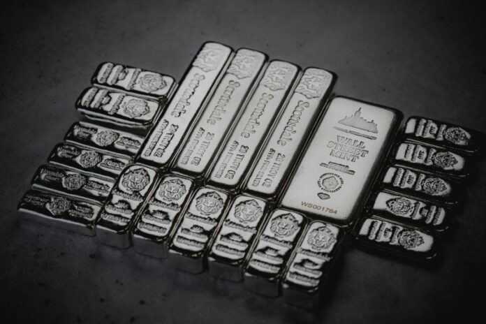 a pile of silver bars sitting on top of a table
